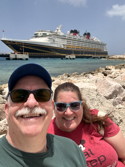 Tim and Beth with the Disney Magic cruise ship in the background